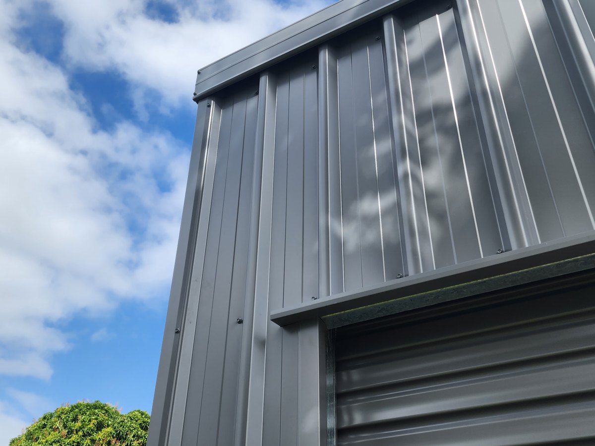 Custom folded corner, barge and roller-door head flashings on a finished COLORBOND® steel shed
